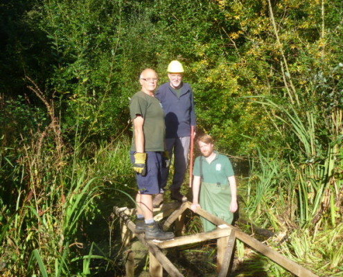 Volunteers working on boardwalk at Bus Company Island