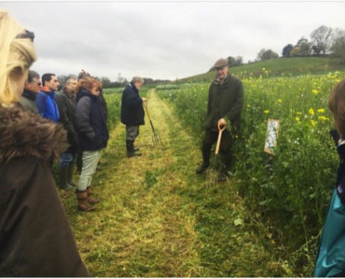 farmerexplaining cover crops to group outdoors