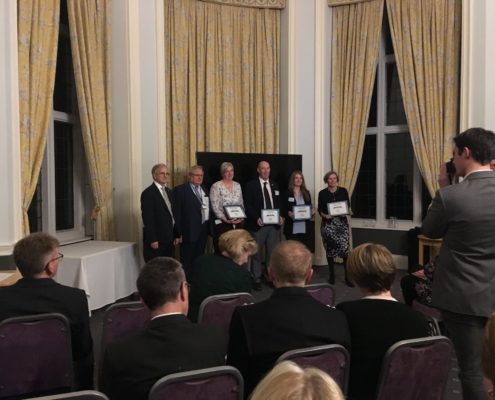 Rachel Green & group holding award certificates.