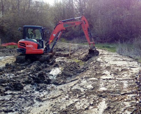 Excavator digging out a pond