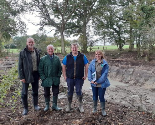 4 people fo rth eGCN Project in a newly created pond.