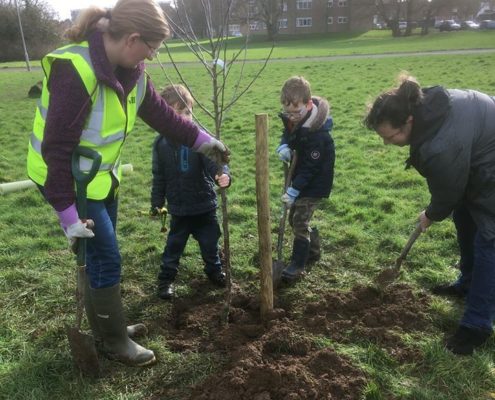 tree planters with children helping